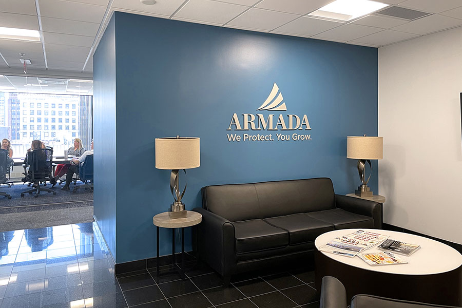 Contact Us - View of the Armada Risk Partners Lobby Room in the Office with Views of a Business Meeting in the Background